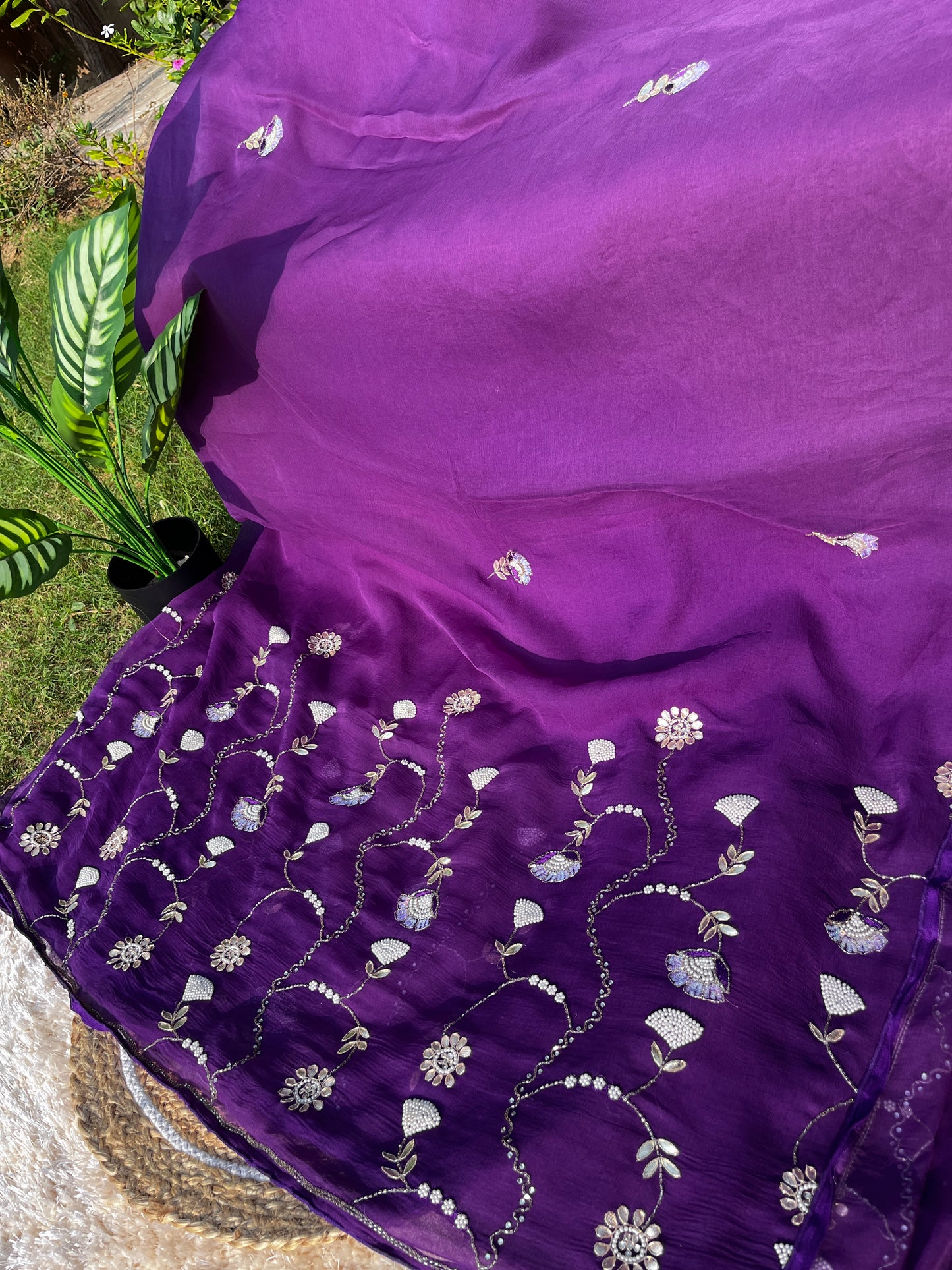 Lightweight Pure Chiffon Saree with rich Kardhana and Gotta Patti embroidery; the pallu showcases a heavy floral handwork design and is embellished with tassels. Full Length picture with Pallu.