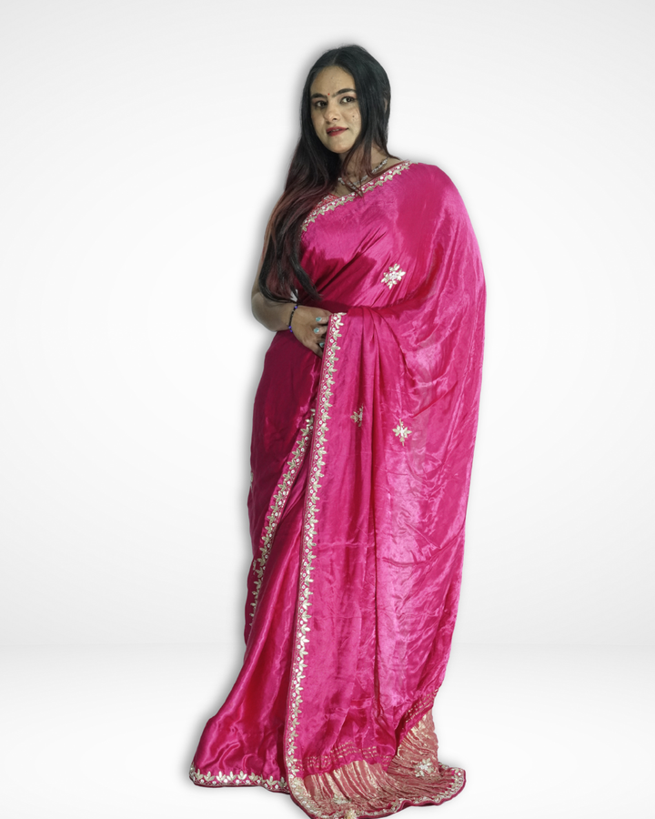 Model wearing a vibrant pink handcrafted silk saree with delicate floral embroidery and elegant gold border, showcasing Amai Jaipur’s sustainable luxury ethnic wear inspired by traditional Jaipur craftsmanship.