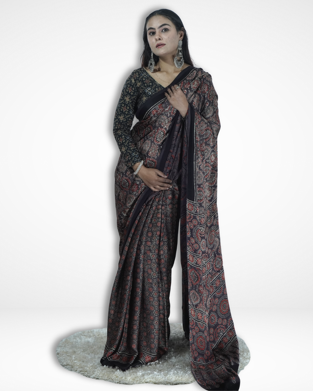 Model wearing a black handcrafted Ajrakh print saree with intricate traditional motifs, showcasing Amai Jaipur’s sustainable luxury ethnic wear inspired by authentic Jaipur textile craftsmanship.