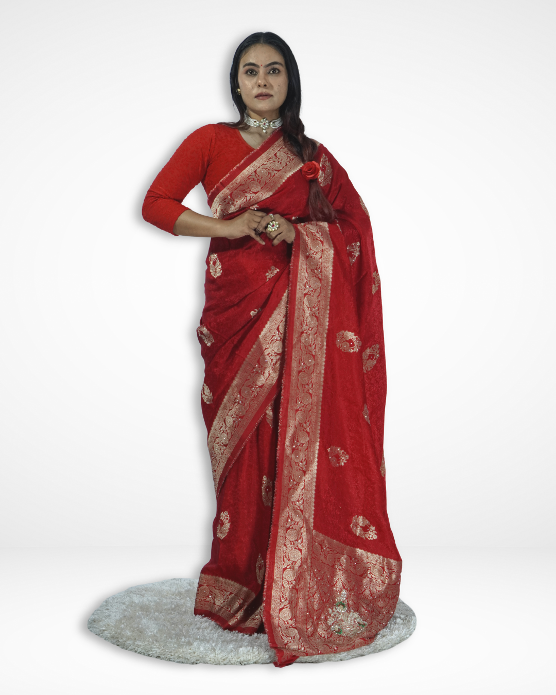 Model wearing a rich red Banarasi silk saree with intricate gold zari weaving and traditional floral motifs, showcasing Amai Jaipur’s handcrafted luxury saree inspired by timeless Indian craftsmanship and festive ethnic fashion.