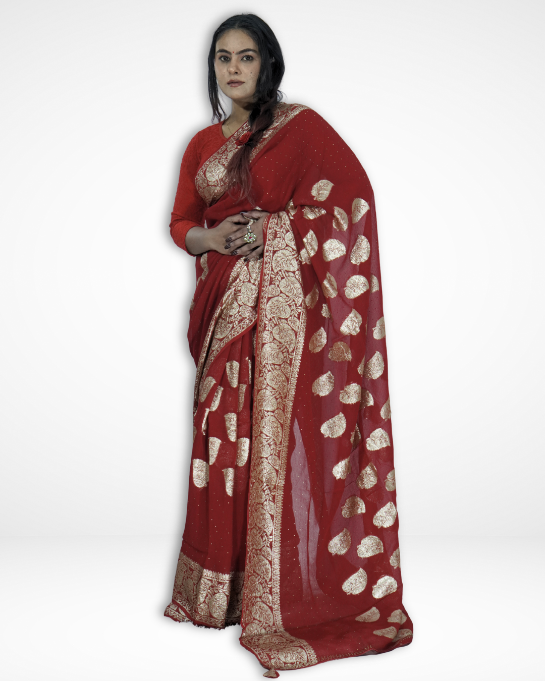 Model draped in an elegant red Banarasi chiffon saree with gold zari leaf motifs and ornate woven border, showcasing Amai Jaipur’s handcrafted luxury saree ideal for bridal wear, weddings, and festive ethnic fashion.