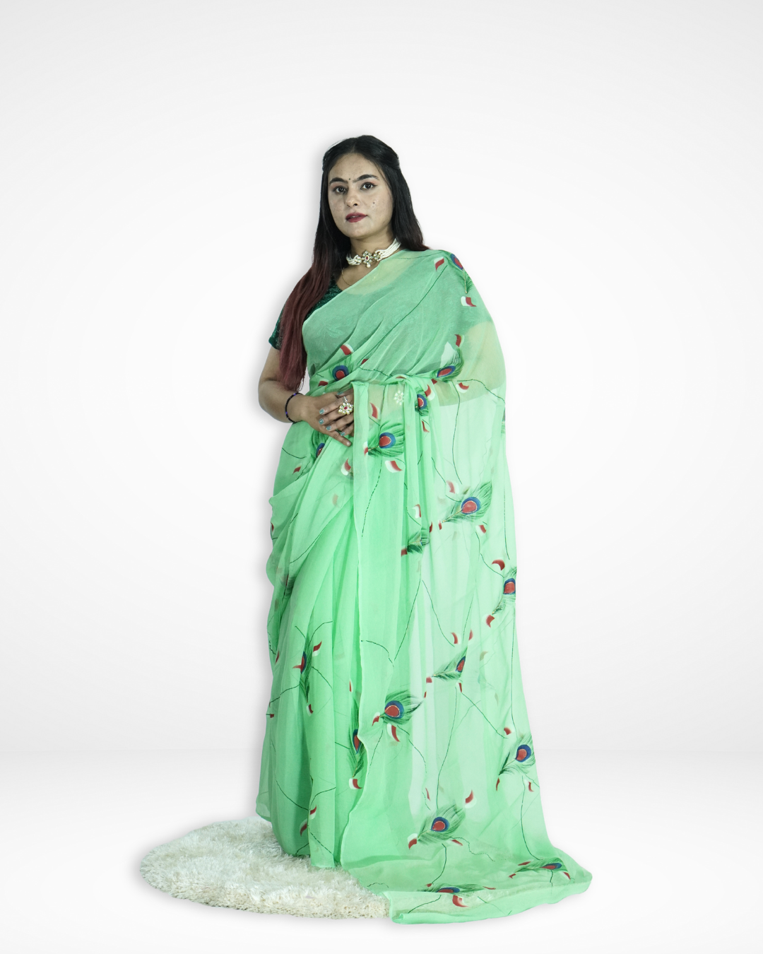 Model wearing a mint green handcrafted saree with elegant peacock feather motifs, showcasing Amai Jaipur’s sustainable luxury ethnic wear inspired by traditional Jaipur craftsmanship.