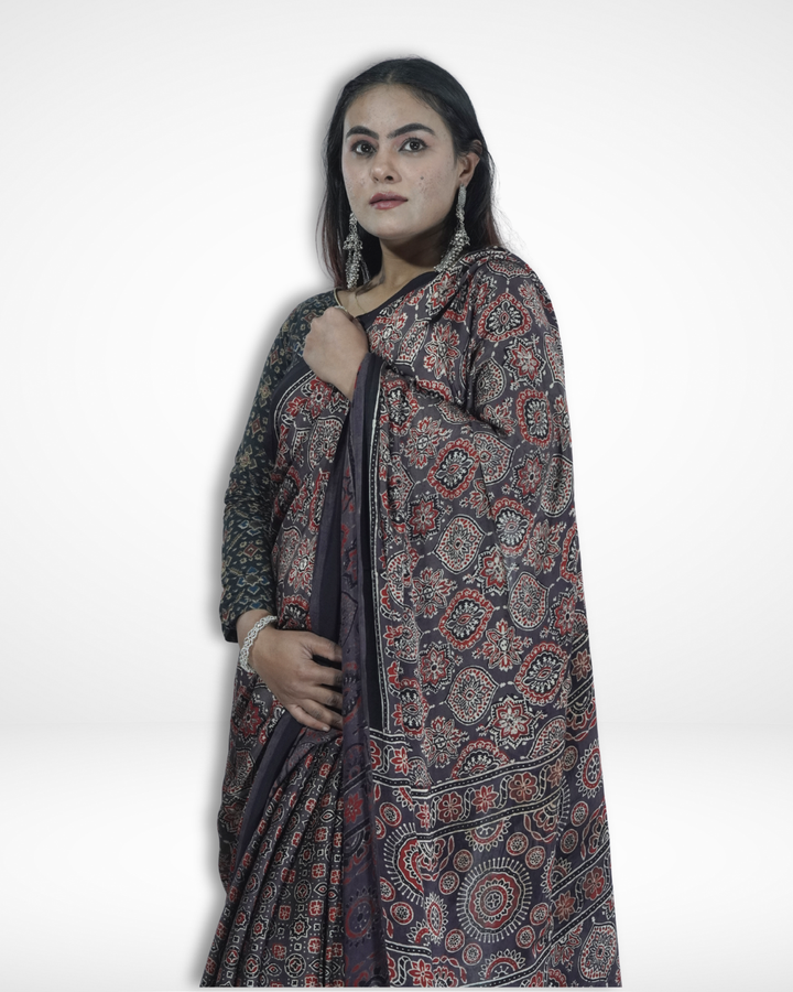 Model draped in a black handcrafted Ajrakh print saree with intricate geometric and floral motifs, showcasing Amai Jaipur’s sustainable luxury ethnic wear inspired by traditional Jaipur textile craftsmanship.