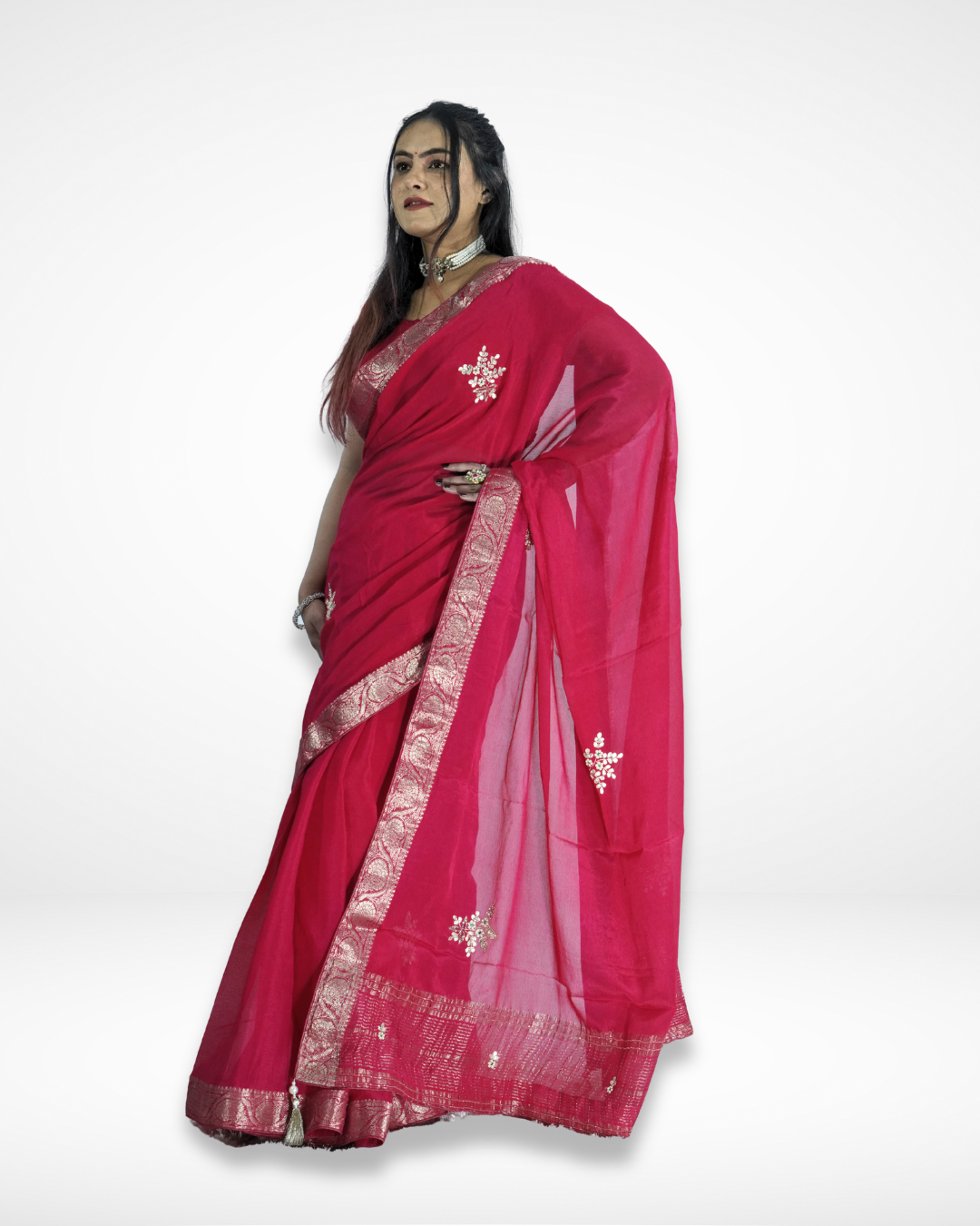 Model draped in a vibrant pink saree featuring a shimmering silver zari border and delicate embroidered motifs, with a flowing pallu that highlights its graceful and festive elegance. ✨