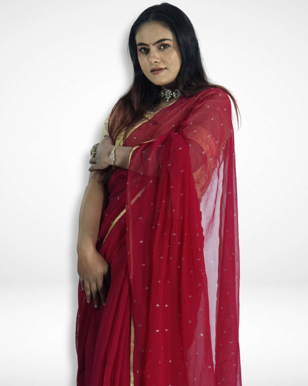 Close-up of a model wearing a red georgette saree with delicate silver sequin embellishments and a subtle gold border, showcasing Amai Jaipur’s handcrafted designer saree perfect for festive occasions, party wear, and elegant ethnic fashion.