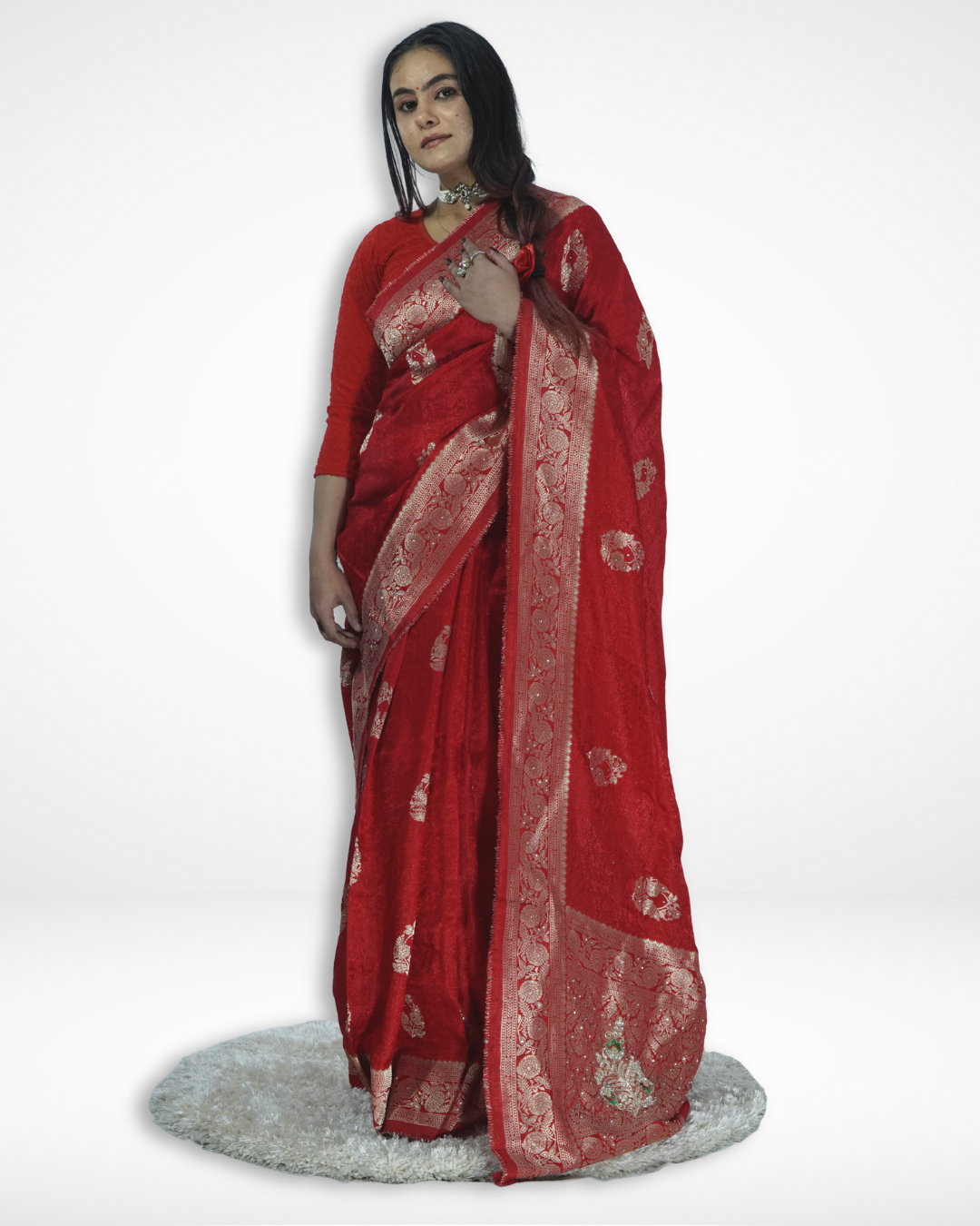 Model draped in an elegant red Banarasi silk saree with intricate gold zari border and traditional woven motifs, showcasing Amai Jaipur’s handcrafted luxury saree perfect for weddings, festive occasions, and timeless ethnic fashion.