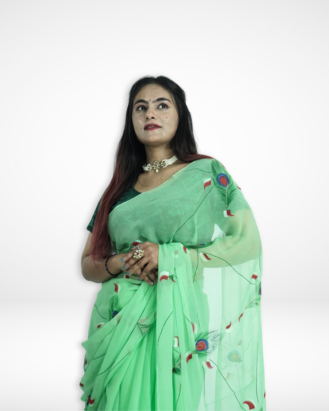 Model wearing a mint green handcrafted saree with delicate peacock feather motifs and sheer drape, showcasing Amai Jaipur’s sustainable luxury ethnic wear inspired by traditional Jaipur craftsmanship.