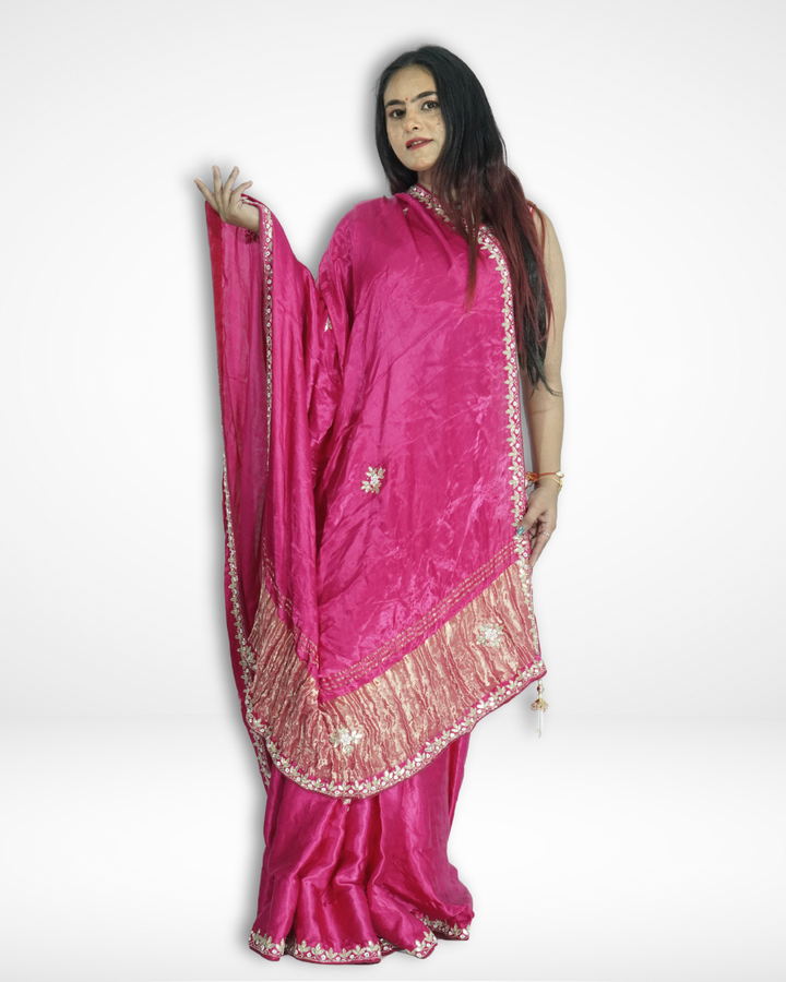 Model posing in a vibrant pink handcrafted silk saree with delicate floral embroidery and elegant gold zari border, showcasing Amai Jaipur’s sustainable luxury ethnic wear inspired by traditional Jaipur craftsmanship.
