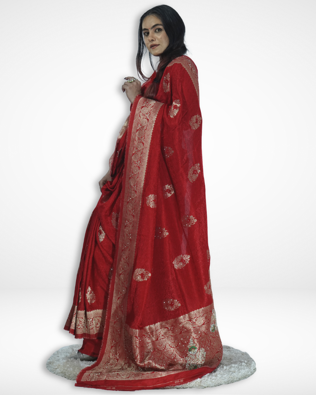 Model showcasing a luxurious red Banarasi silk saree with intricate gold zari border and traditional woven motifs, highlighting Amai Jaipur’s handcrafted designer saree perfect for weddings, festive occasions, and timeless ethnic elegance.