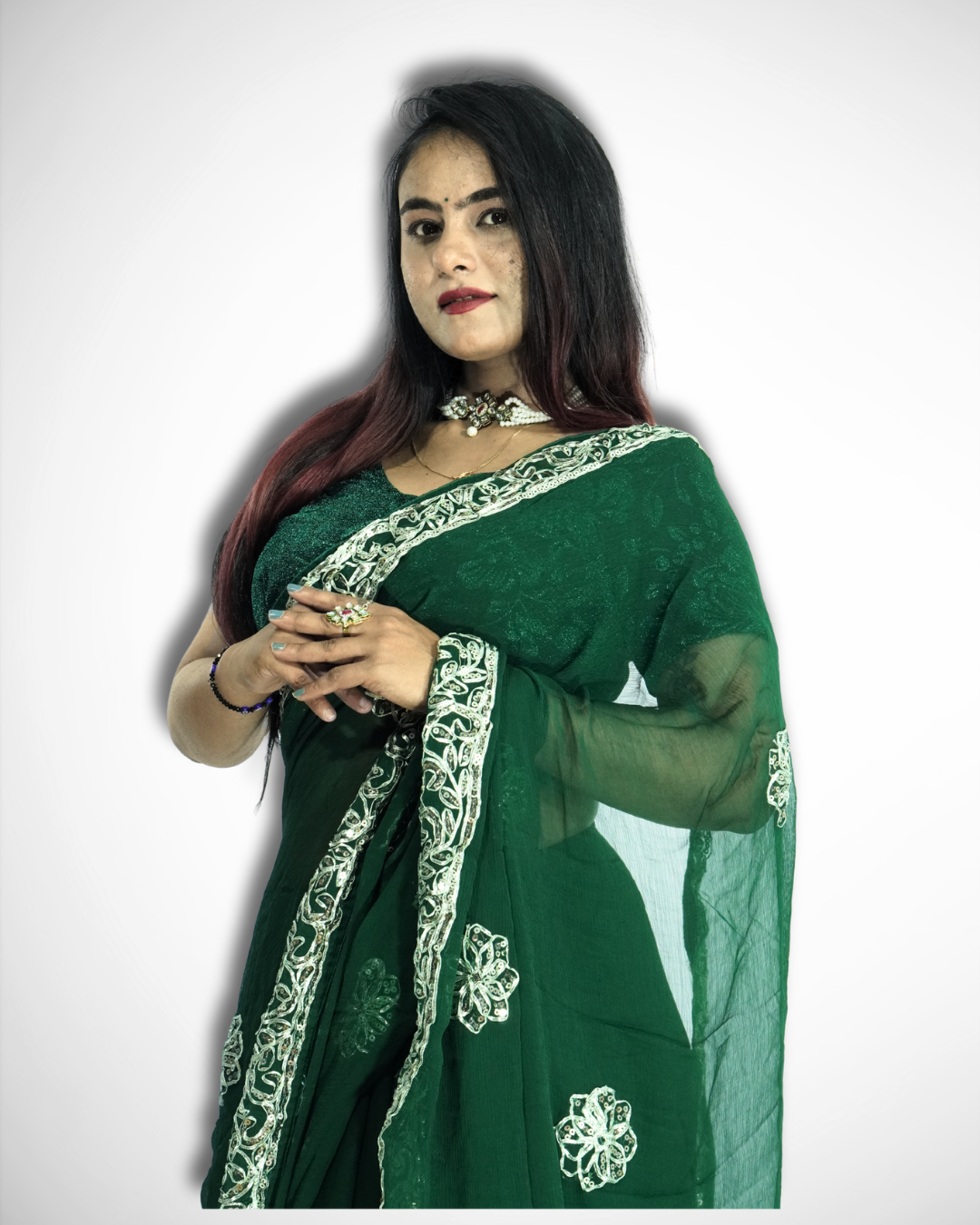 Woman modeling an elegant emerald green saree with intricate silver embroidered vine border and delicate floral butta motifs, paired with traditional jewelry and a sheer flowing pallu. ✨