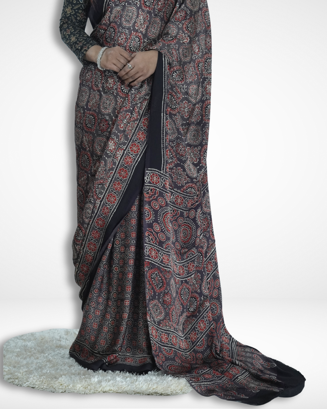 Close-up of a black Ajrakh print saree with intricate traditional motifs and detailed border, highlighting Amai Jaipur’s handcrafted sustainable saree inspired by authentic Jaipur textile craftsmanship.