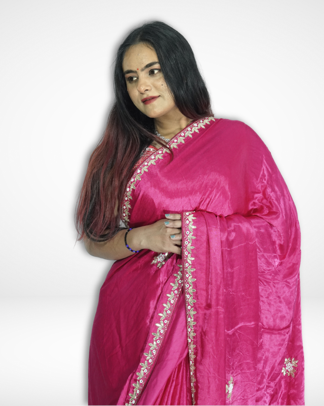 Close-up of a model wearing a vibrant pink handcrafted silk saree with delicate floral embroidery and elegant gold border, highlighting Amai Jaipur’s sustainable luxury ethnic wear inspired by traditional Jaipur craftsmanship.