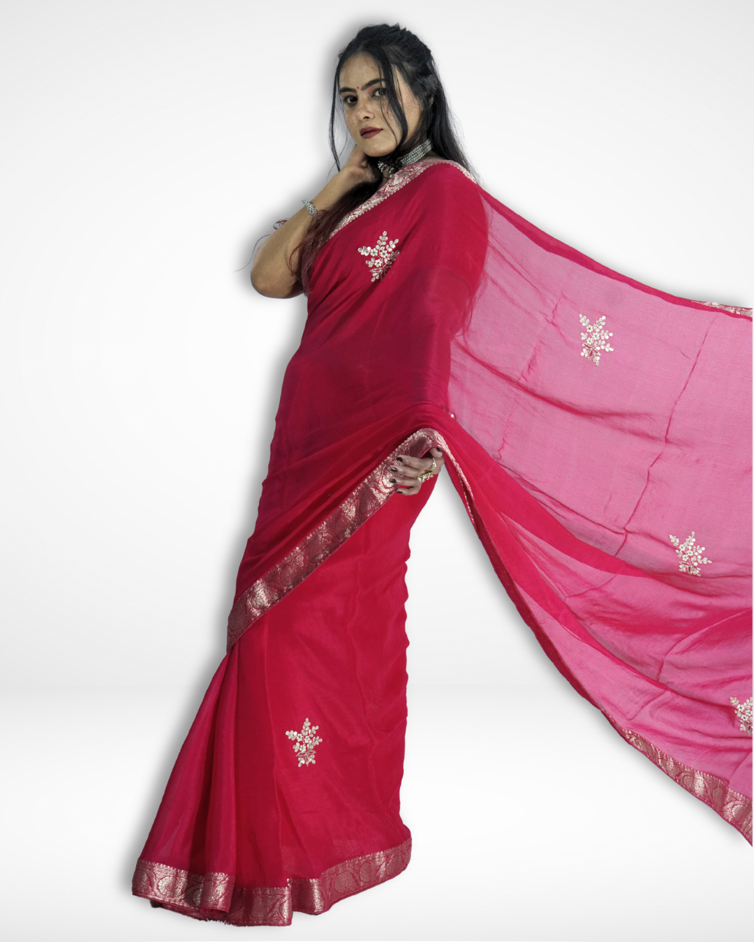 Model wearing a vibrant pink saree with a shimmering silver zari border and delicate floral motifs, gracefully posing with the flowing pallu extended to showcase the saree’s elegant drape and lightweight texture. ✨