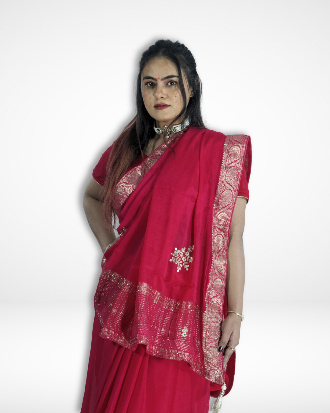 Close-up of a model wearing a vibrant pink saree with an intricate silver zari border and delicate embroidered motifs, showcasing the elegant pallu and festive detailing. ✨