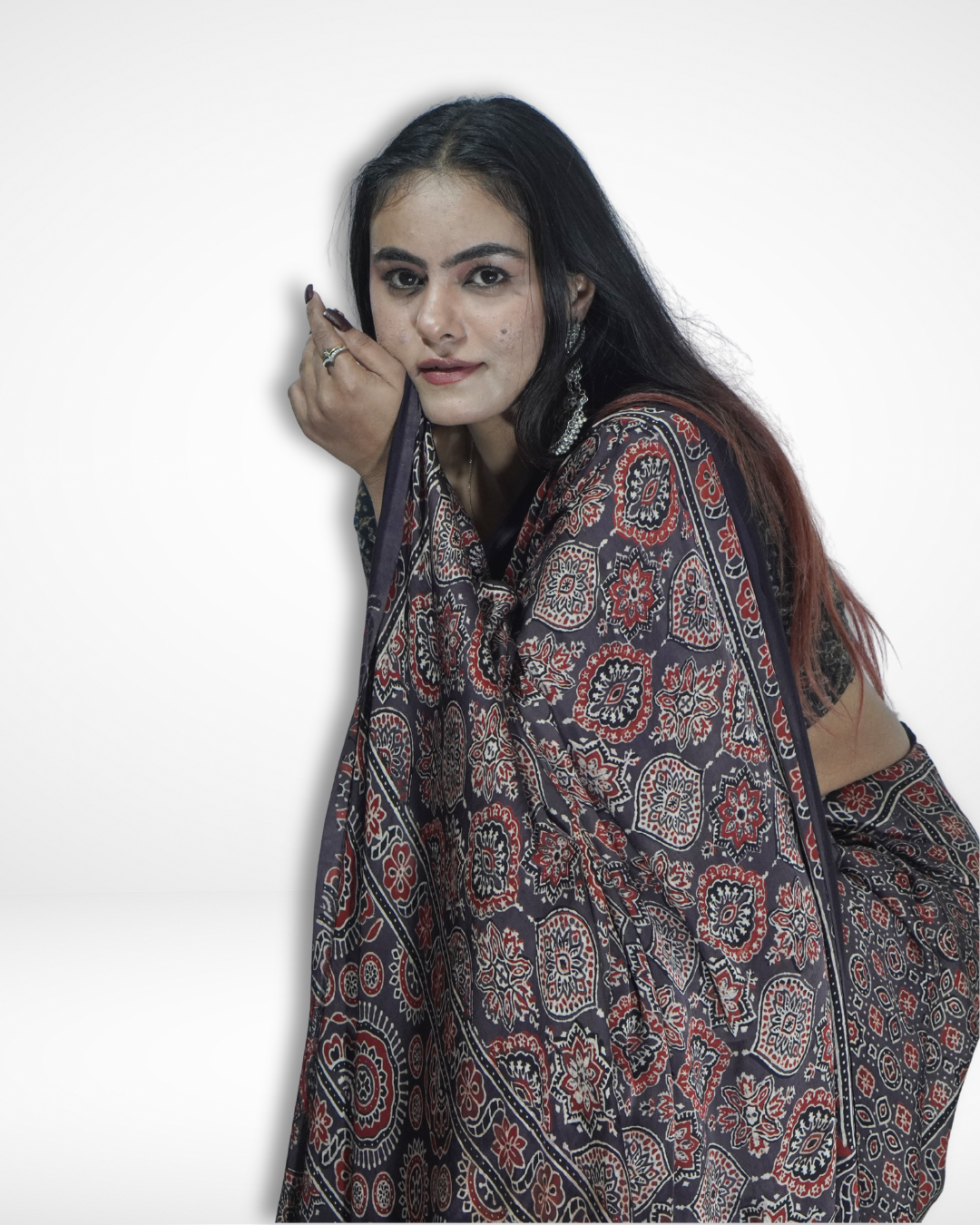 Model posing in a black handcrafted Ajrakh print saree with intricate floral and geometric motifs, highlighting Amai Jaipur’s sustainable luxury ethnic wear inspired by traditional Jaipur textile craftsmanship.