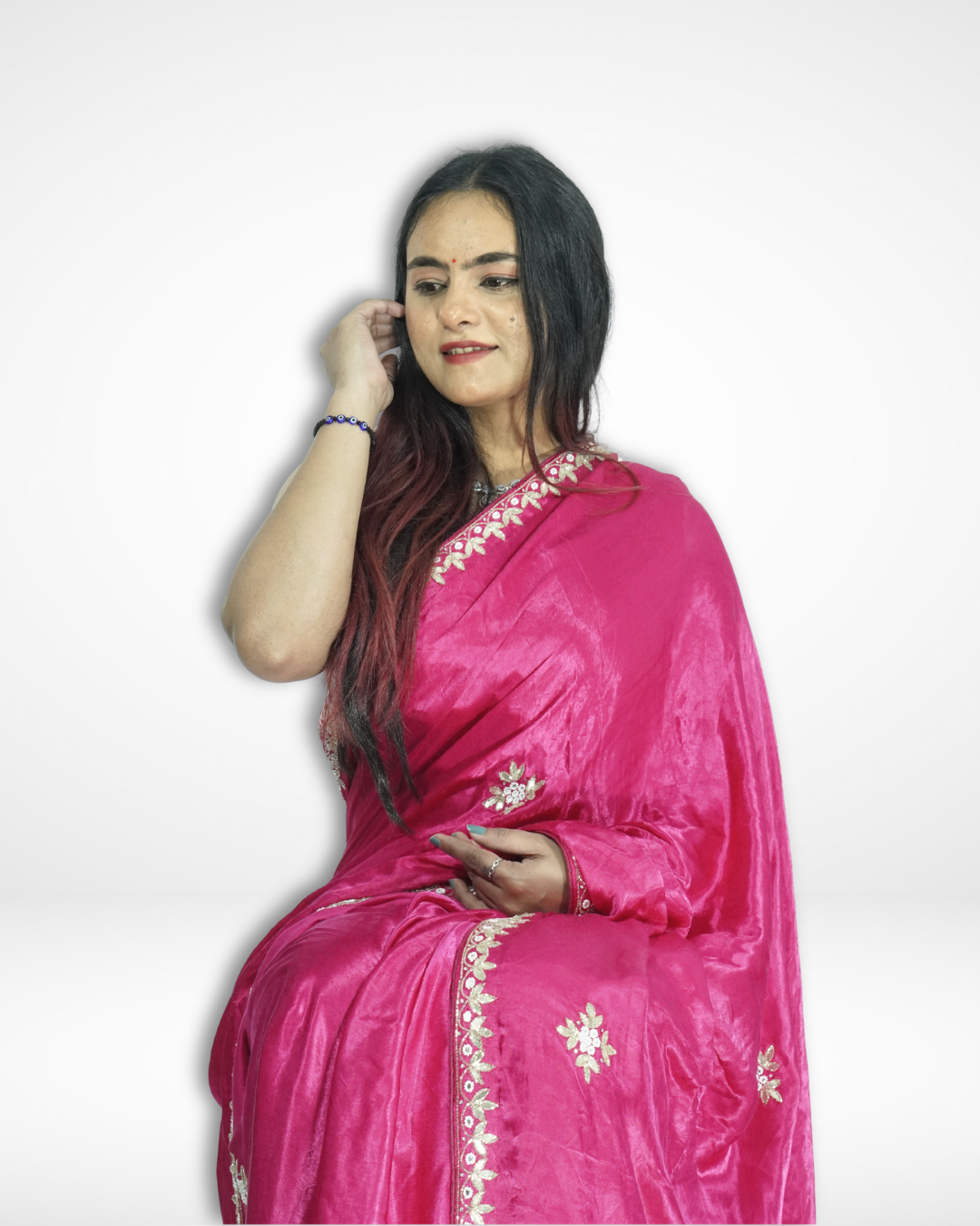 Model sitting gracefully in a vibrant pink handcrafted silk saree with delicate floral embroidery and elegant gold border, showcasing Amai Jaipur’s sustainable luxury ethnic wear inspired by traditional Jaipur craftsmanship.