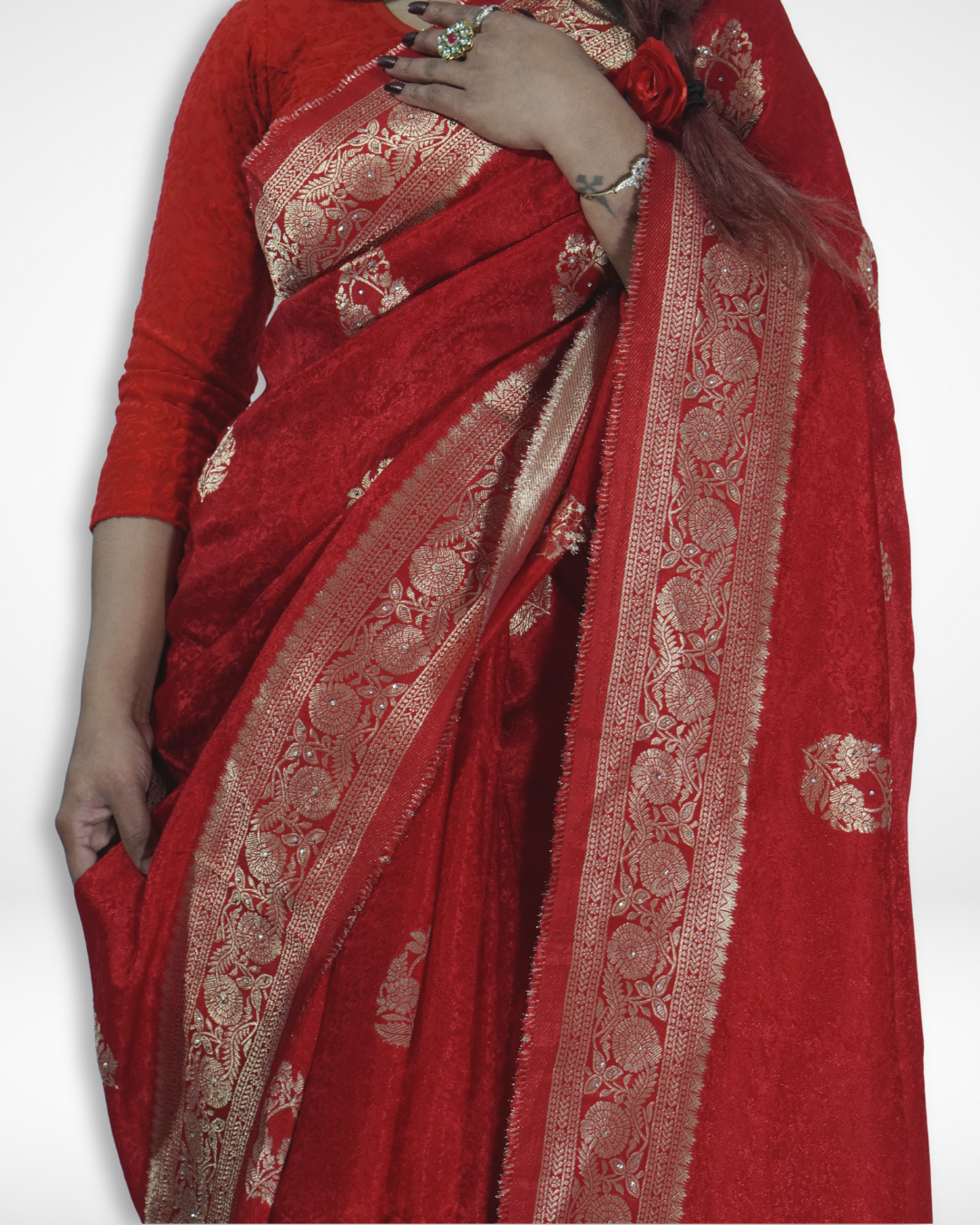 Close-up of a luxurious red Banarasi silk saree with intricate gold zari border and traditional floral weaving, highlighting Amai Jaipur’s handcrafted designer saree perfect for weddings, bridal wear, and festive ethnic fashion.
