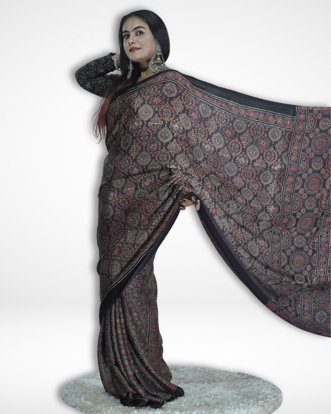 Model elegantly showcasing a black Ajrakh print saree with intricate traditional motifs and detailed border, highlighting Amai Jaipur’s handcrafted sustainable luxury saree inspired by authentic Jaipur textile craftsmanship.