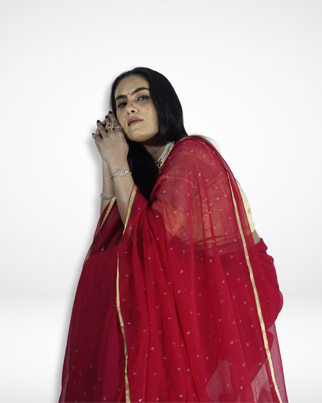 Close-up of a model draped in a red georgette saree with delicate silver sequin detailing and a subtle gold border, showcasing Amai Jaipur’s elegant handcrafted designer saree perfect for festive wear, evening parties, and contemporary ethnic fashion.
