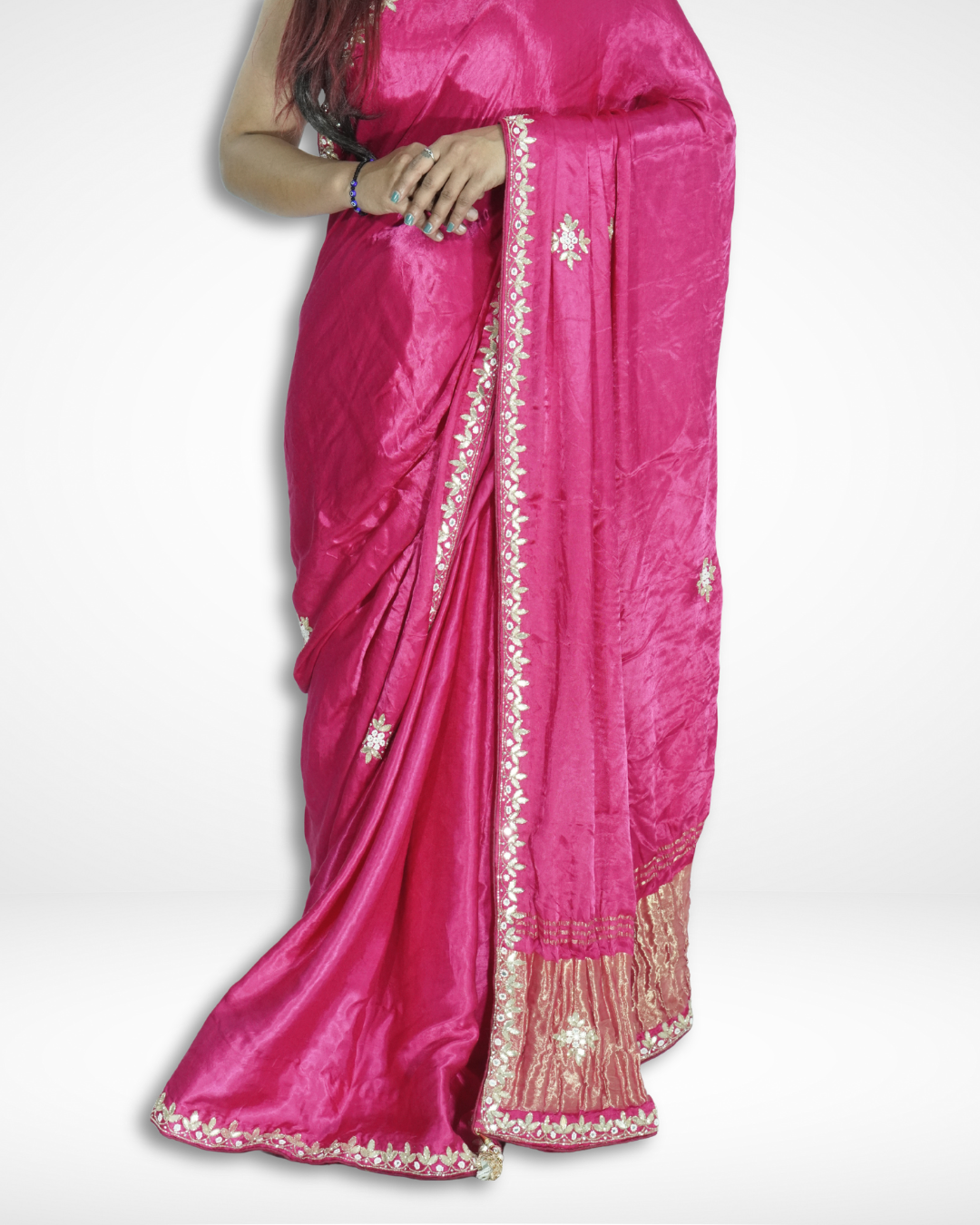 Close-up of a vibrant pink handcrafted silk saree with delicate floral embroidery and elegant gold zari border, highlighting Amai Jaipur’s sustainable luxury saree inspired by traditional Jaipur craftsmanship.