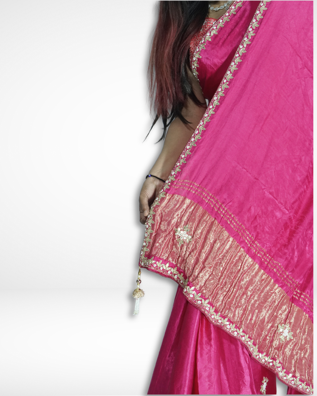 Close-up of a vibrant pink handcrafted silk saree pallu with delicate floral embroidery and rich gold zari border detailing, highlighting Amai Jaipur’s sustainable luxury saree inspired by traditional Jaipur craftsmanship.