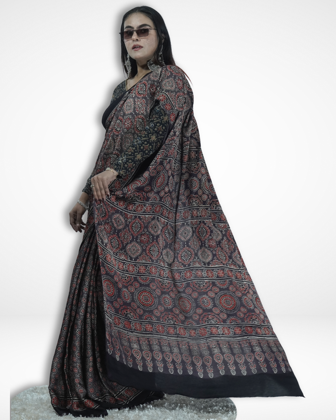 Model wearing a black handcrafted Ajrakh print saree with intricate traditional motifs and detailed border, showcasing Amai Jaipur’s sustainable luxury saree inspired by authentic Jaipur textile craftsmanship.