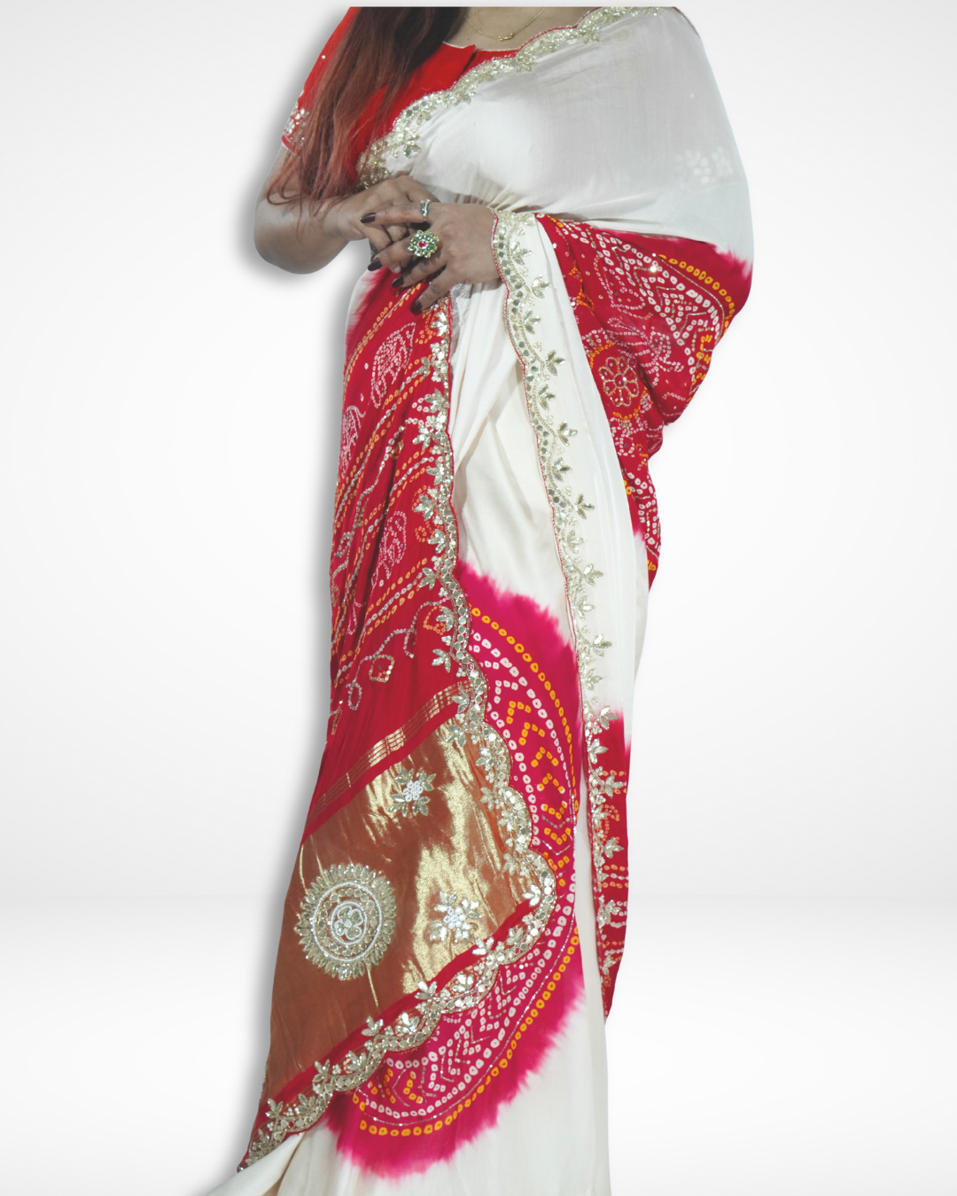 Model draped in an ivory handcrafted saree with vibrant red bandhani patterns and ornate gold zari embroidered border, showcasing Amai Jaipur’s sustainable luxury saree inspired by traditional Jaipur craftsmanship.