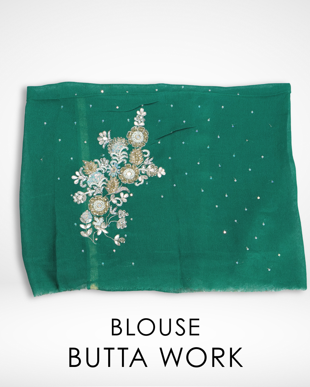 Close-up of emerald green blouse fabric featuring intricate floral embroidery and delicate butta work with subtle sequin accents, designed to complement Amai Jaipur’s elegant chiffon saree collection. ✨