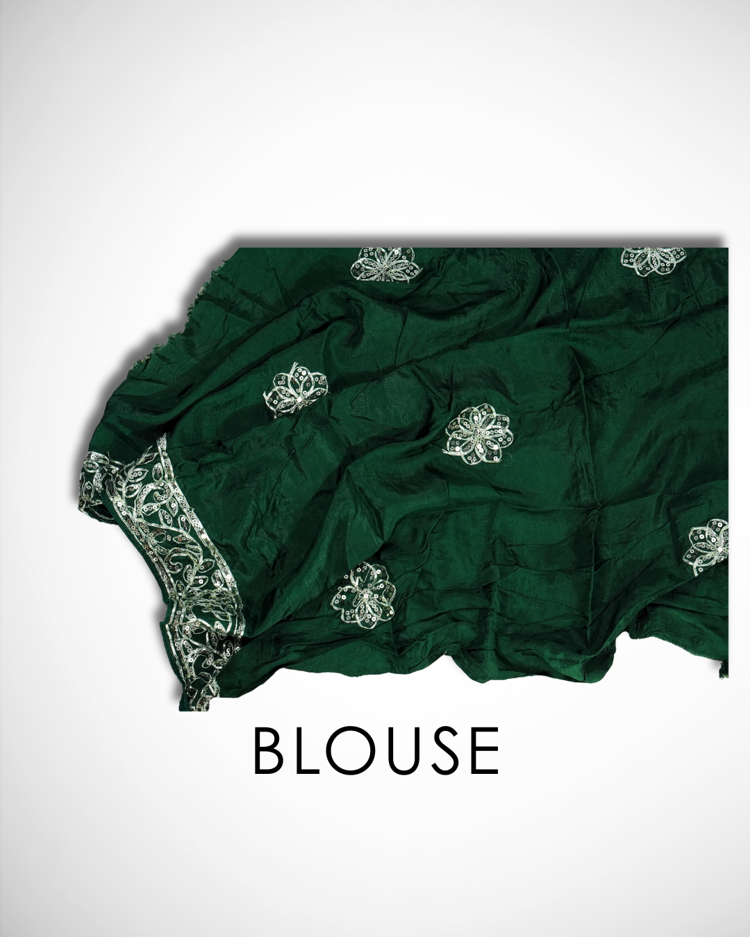 Dark green saree blouse fabric with delicate silver sequin floral butta motifs scattered across the fabric and an ornate embroidered border along one edge. ✨