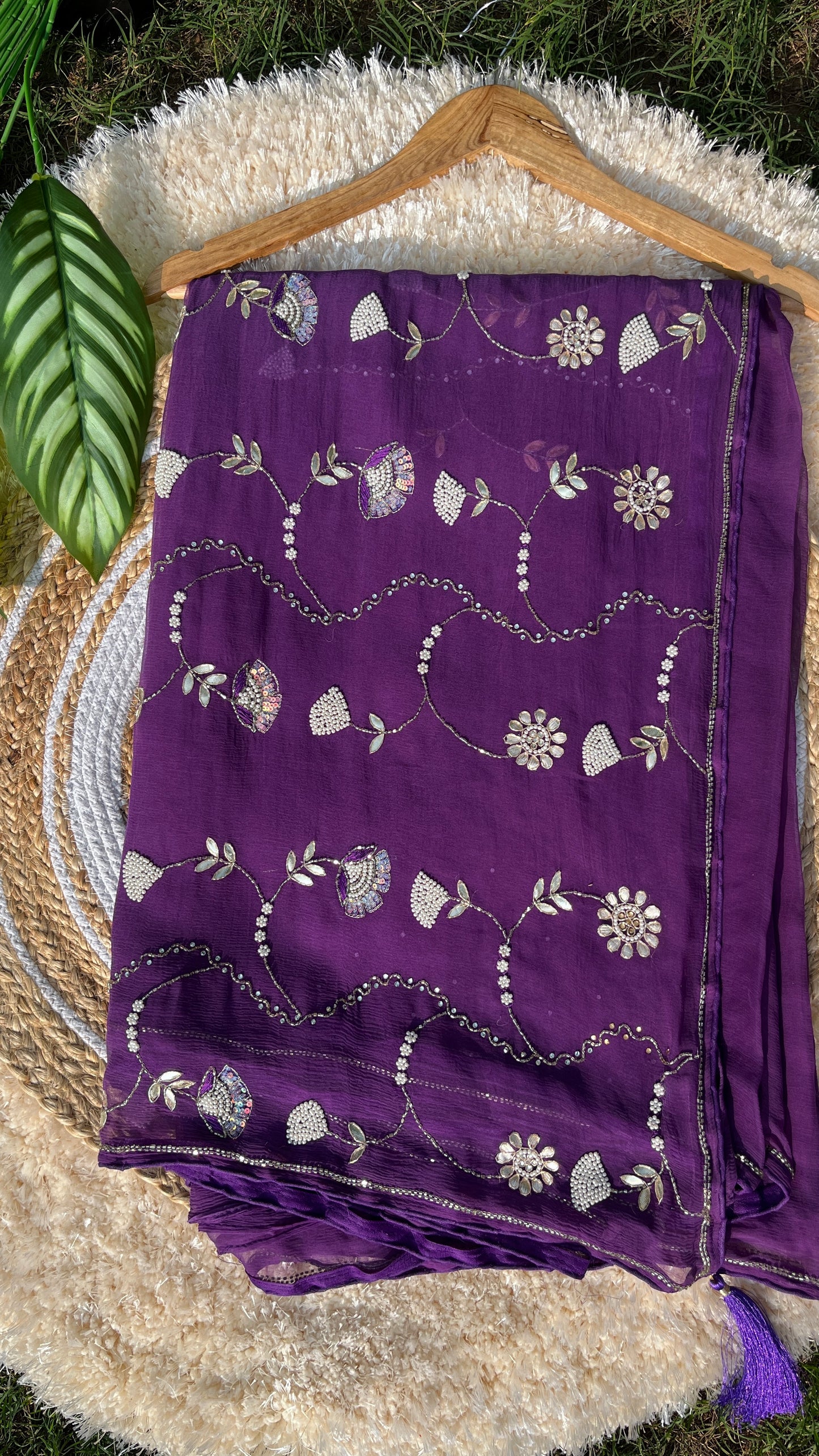 Lightweight Pure Chiffon Saree with rich Kardhana and Gotta Patti embroidery; the pallu showcases a heavy floral handwork design and is embellished with tassels. Front Picture of the saree.