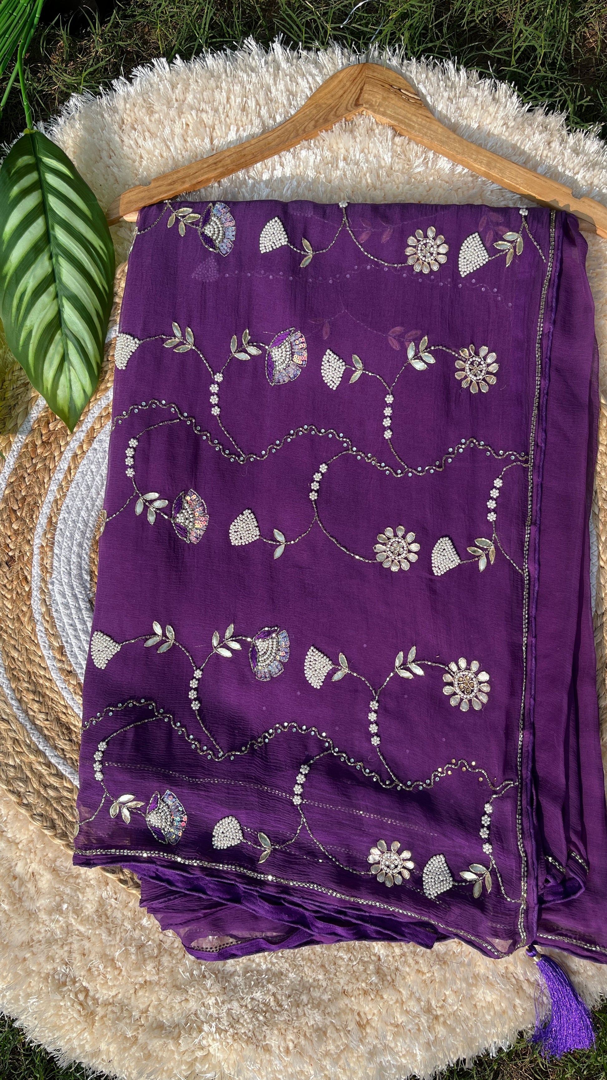 Lightweight Pure Chiffon Saree with rich Kardhana and Gotta Patti embroidery; the pallu showcases a heavy floral handwork design and is embellished with tassels. Front Picture of the saree.