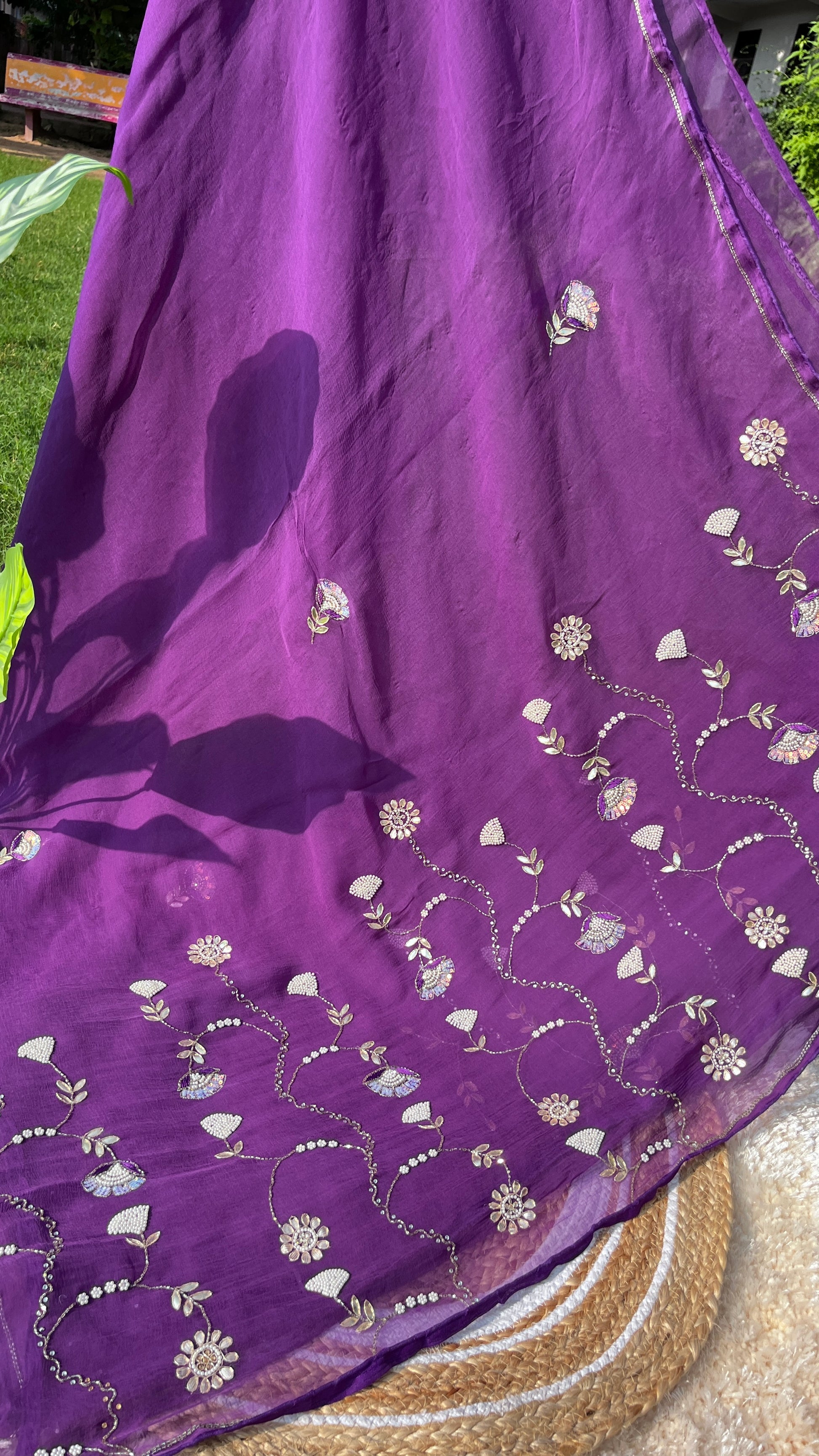 Lightweight Pure Chiffon Saree with rich Kardhana and Gotta Patti embroidery; the pallu showcases a heavy floral handwork design and is embellished with tassels. Picture of the Pallu of the Saree from a different Angle.