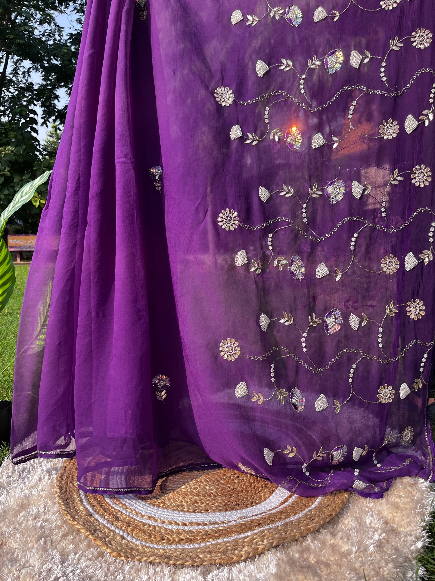 Lightweight Pure Chiffon Saree with rich Kardhana and Gotta Patti embroidery; the pallu showcases a heavy floral handwork design and is embellished with tassels.