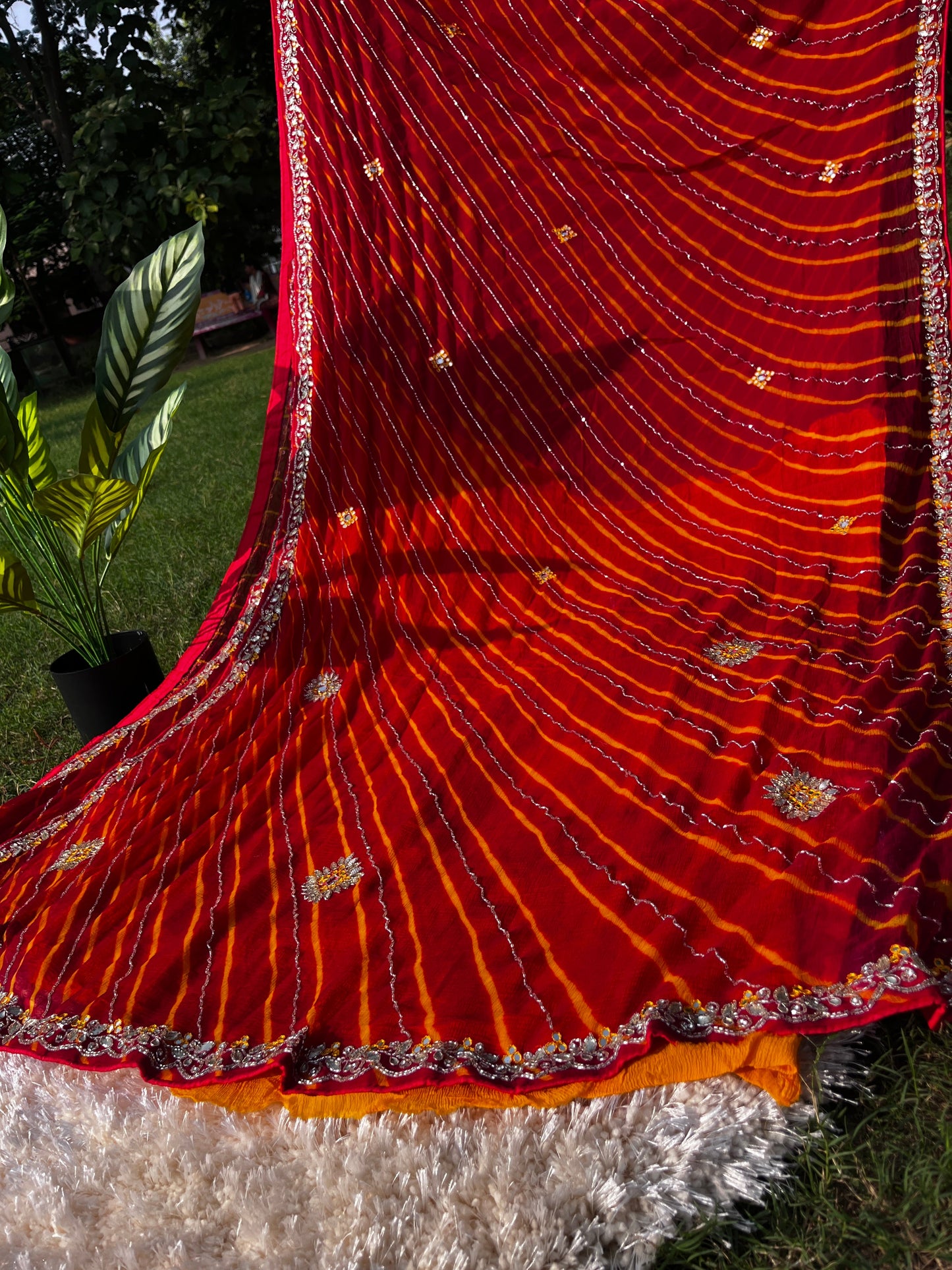 Vibrant Red Lehariya Pure Chiffon Saree featuring Heavy Kardhana and Gotta Patti Butta Work. Traditional Rajasthani handwork for wedding and festive wear. This Picture Showcases the Rich Pallu of the Saree.