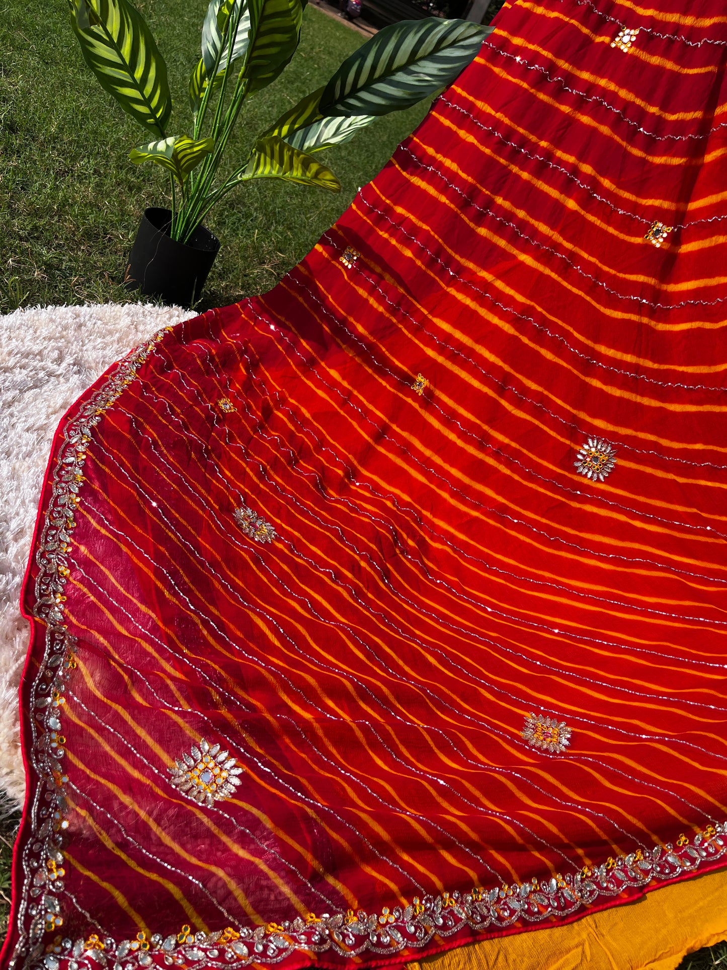 Vibrant Red Lehariya Pure Chiffon Saree featuring Heavy Kardhana and Gotta Patti Butta Work. Traditional Rajasthani handwork for wedding and festive wear. This Picture is highlighting the pallu of the saree from a different Angle.