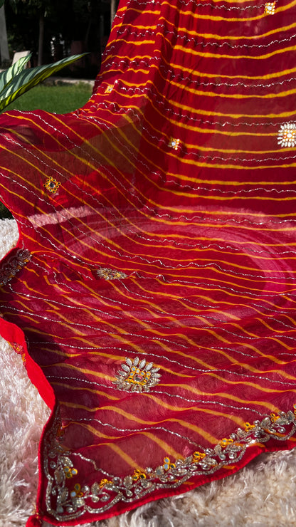 Vibrant Red Lehariya Pure Chiffon Saree featuring Heavy Kardhana and Gotta Patti Butta Work. Traditional Rajasthani handwork for wedding and festive wear. This Picture showcases the Heavy and Rich Border of the Saree.