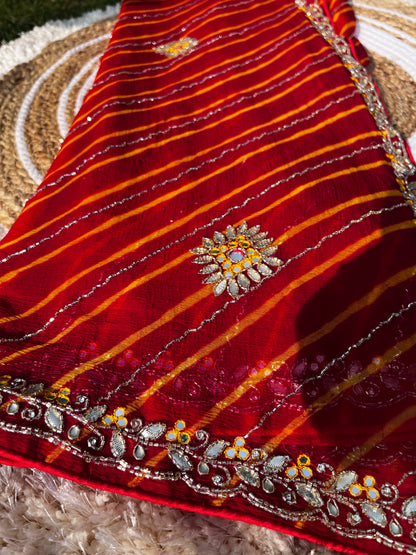 Vibrant Red Lehariya Pure Chiffon Saree featuring Heavy Kardhana and Gotta Patti Butta Work. Traditional Rajasthani handwork for wedding and festive wear. This Picture has a full focus on the Lehariya and Butta work of the Saree.