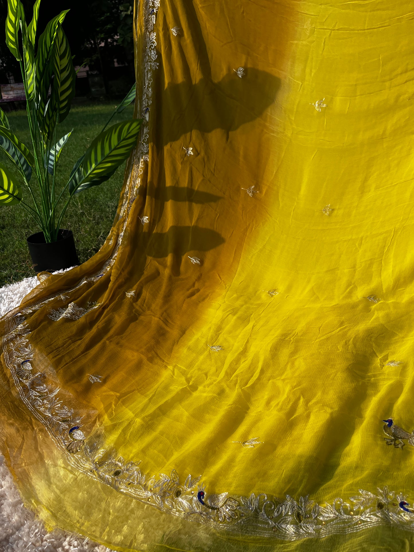 Lightweight Pure Chiffon Saree hand-embroidered with traditional Aari Tari and sparkling Peacock Butta motifs, ideal for wedding wear. This is a Picture of Pallu