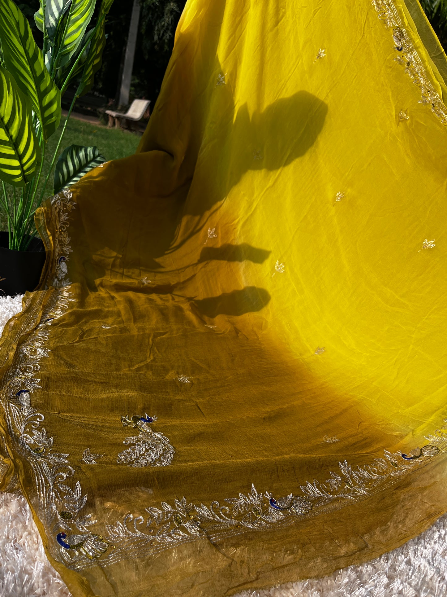 Lightweight Olive Green and Yellow Pure Chiffon Saree hand-embroidered with traditional Aari Tari and sparkling Peacock Aari Butta motifs, perfect for wedding wear. This is a Picture of Pallu From a different Angle.