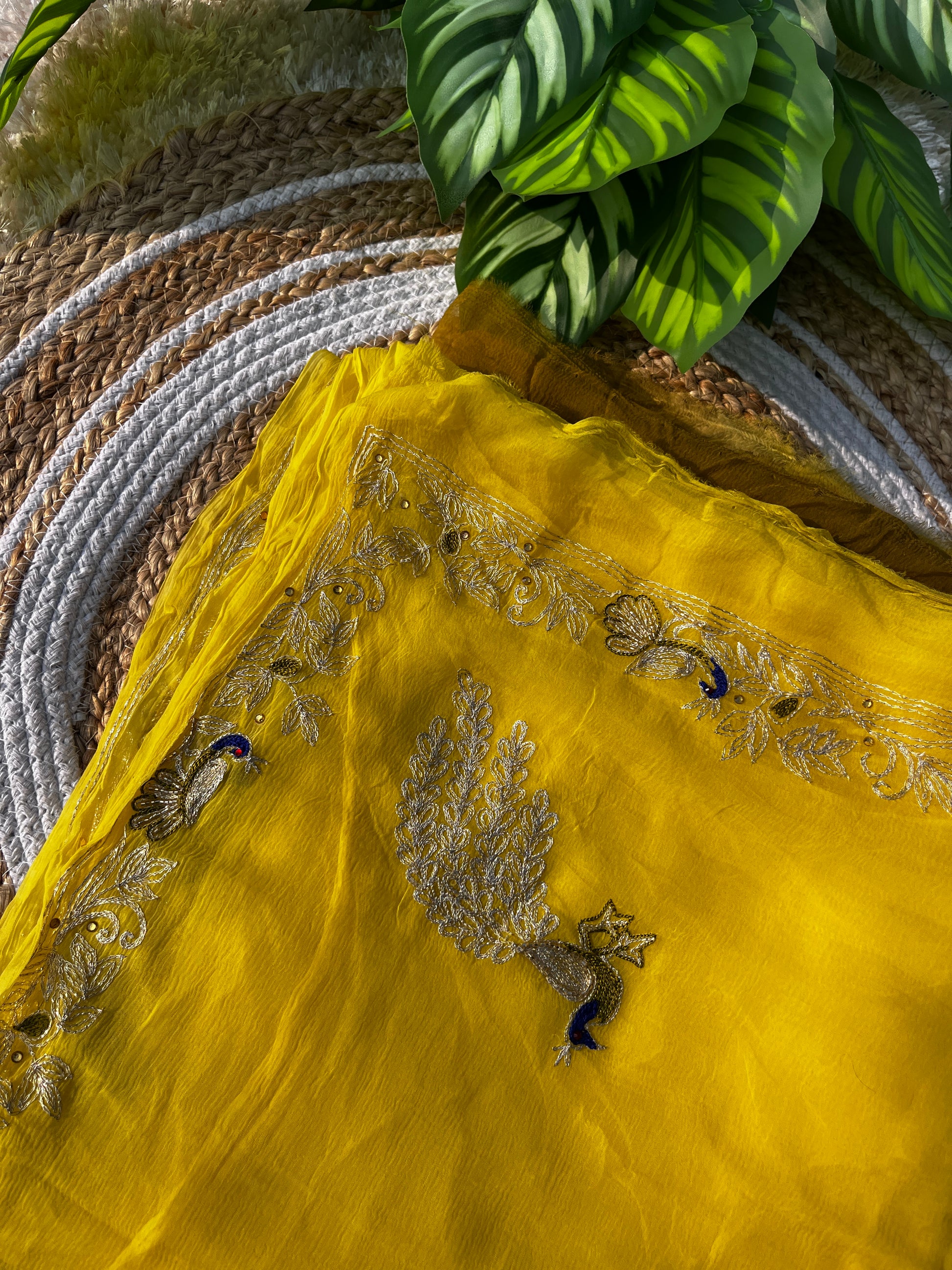 Lightweight Olive Green and Yellow Pure Chiffon Saree hand-embroidered with traditional Aari Tari and sparkling Peacock Aari Butta motifs, perfect for wedding wear.