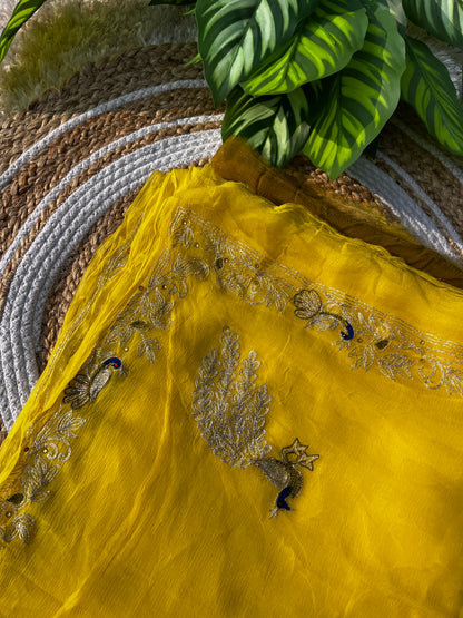 Lightweight Olive Green and Yellow Pure Chiffon Saree hand-embroidered with traditional Aari Tari and sparkling Peacock Aari Butta motifs, perfect for wedding wear.