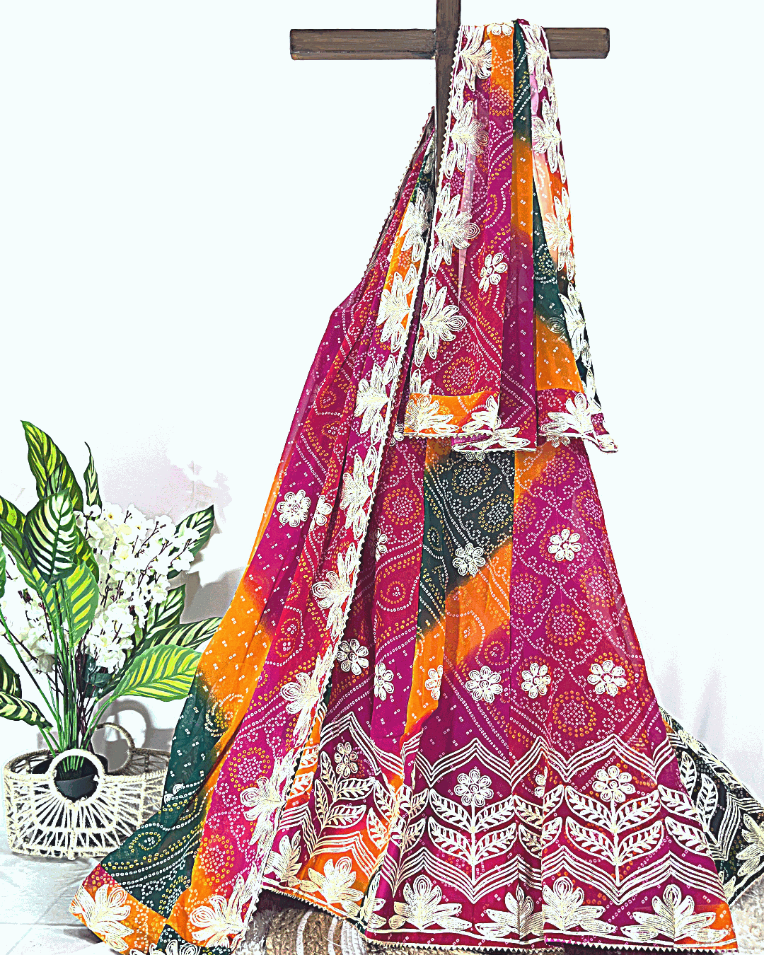 Multicolored Rajasthani Bandhani Lehenga Skirt featuring intricate Gota Patti border embroidery on vibrant pink and orange Bandhej silk.