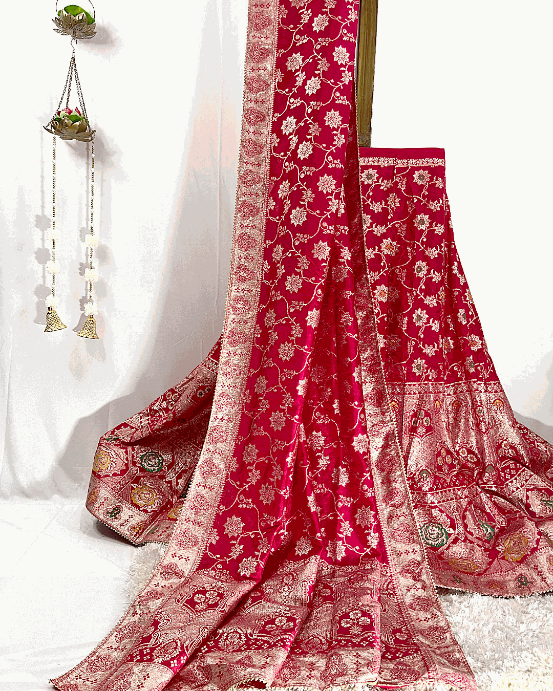 Full view of a Red Dola Silk Lehenga Choli set featuring heavy Meenakari Zari Weaving and a richly detailed border, perfect for bridal and festive occasions.