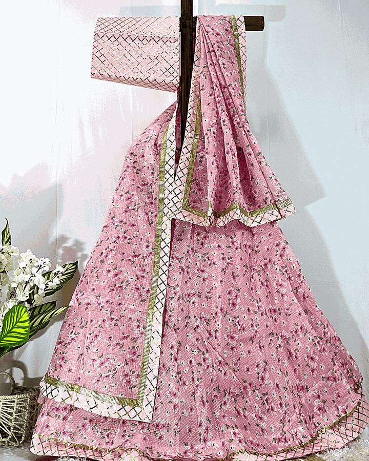 Full display of a traditional Rajasthani Bandhej Lehenga Choli set on a stand, featuring vibrant multicolored tie-dye patterns and heavy floral Gota Patti embroidery on the borders, suitable for weddings and festivals.