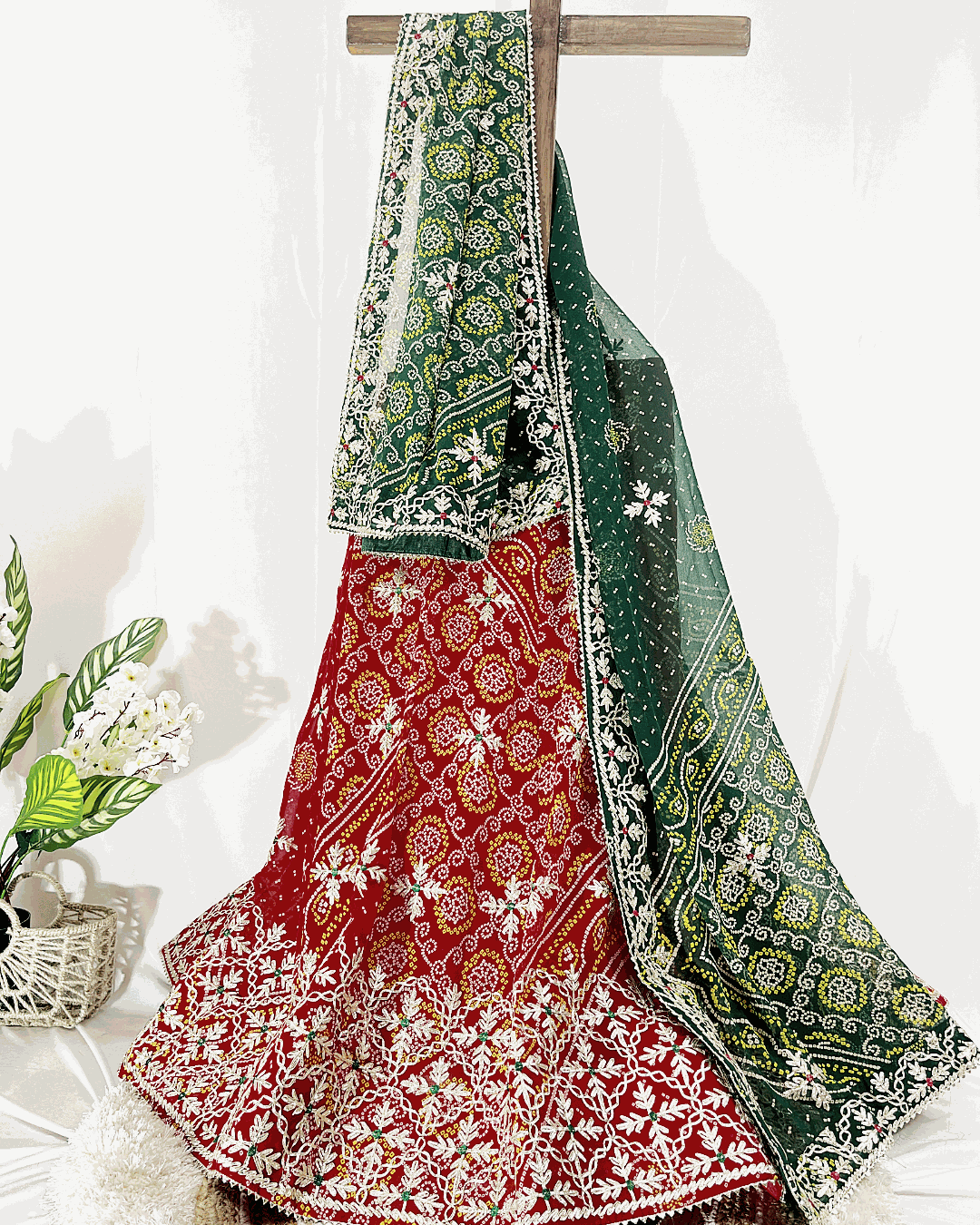 Detailed view of the light pink floral print lehenga ghagra and dupatta, showcasing the gold crisscross Gota Patti border and lightweight fabric texture.