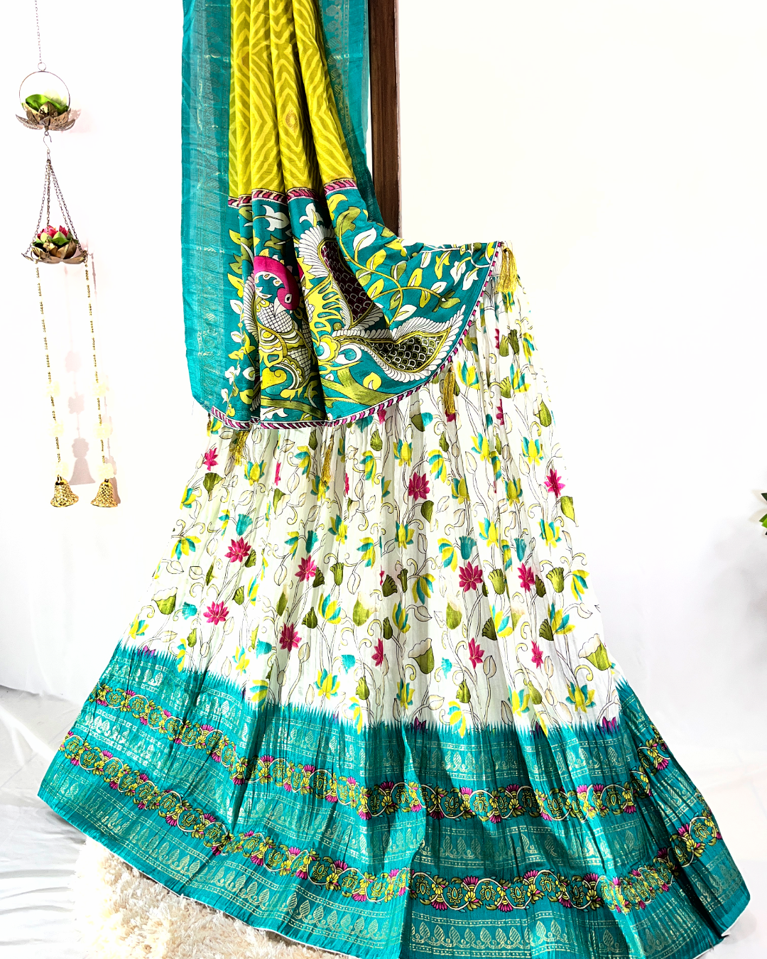 Close-up view of the light pink floral digitally printed cotton lehenga skirt, showcasing the detailed gold crisscross Gota Patti border and lightweight texture, suitable for summer festive occasions.