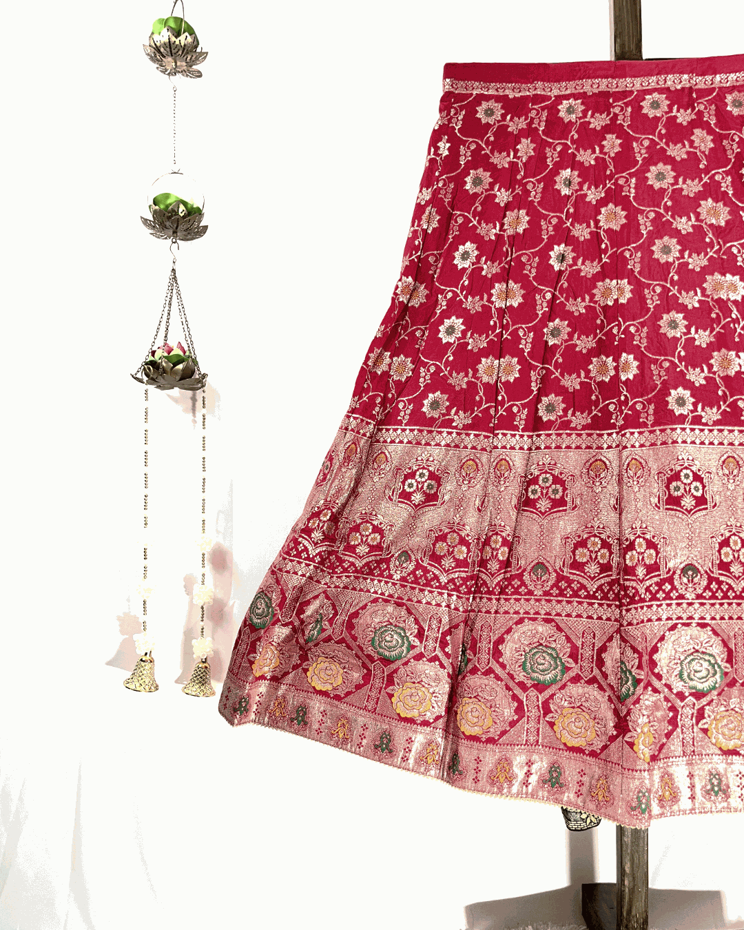 Close-up view of the Red Dola Silk Lehenga skirt flare, showcasing the intricate gold Meenakari Zari Weaving and rich border detail, perfect for bridal wear.