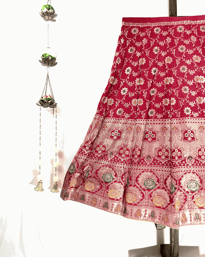 Close-up view of the Red Dola Silk Lehenga skirt flare, showcasing the intricate gold Meenakari Zari Weaving and rich border detail, perfect for bridal wear.